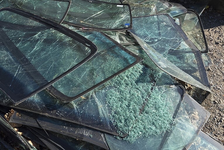 Pile Of Cracked Car Windshields On The Ground
